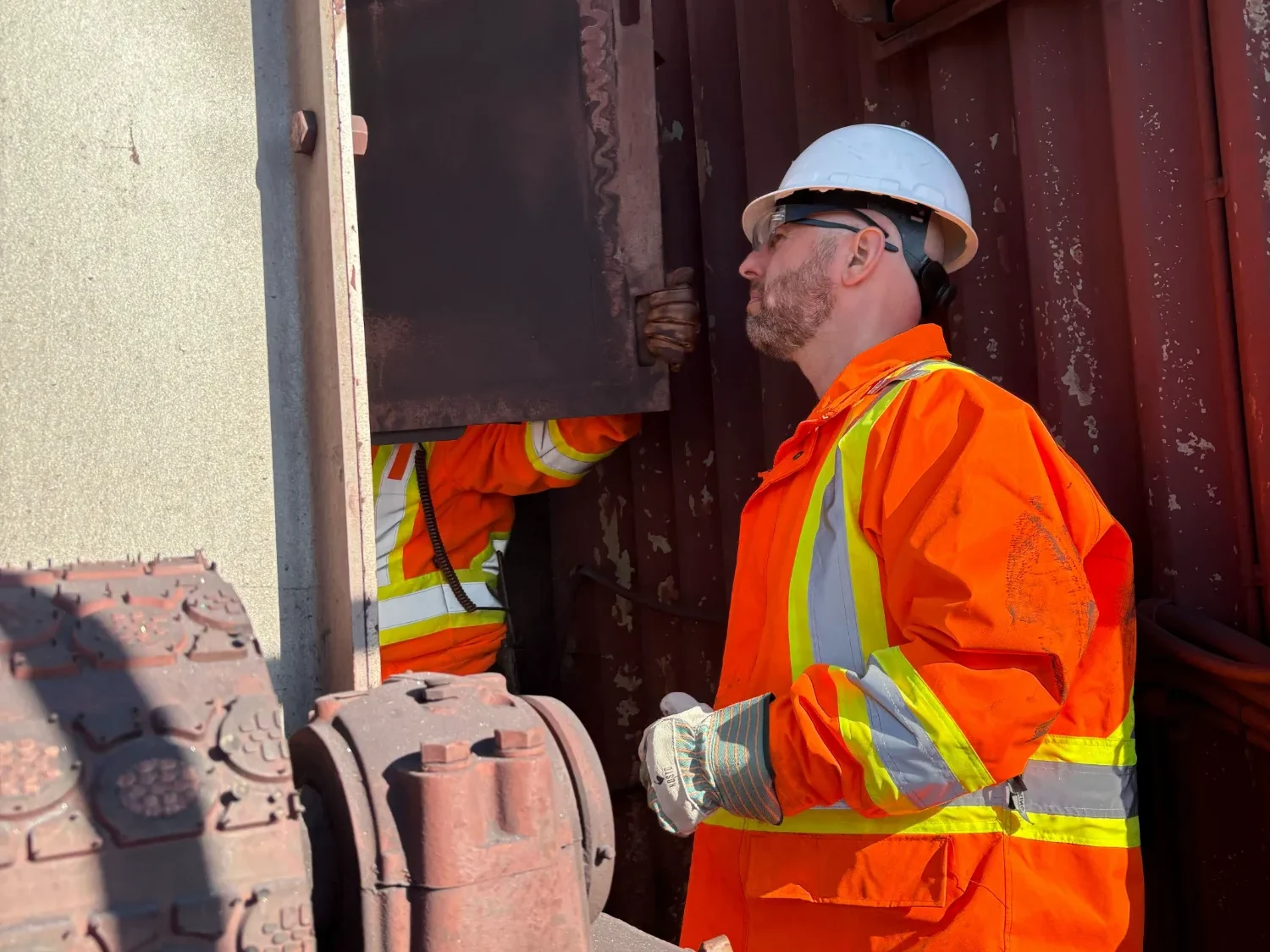 Worker in high-visibility clothing inspecting his equipment at the start of the shift